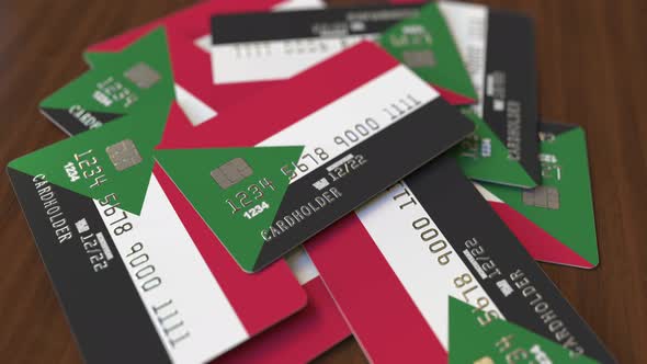 Pile of Credit Cards with Flag of Sudan alt