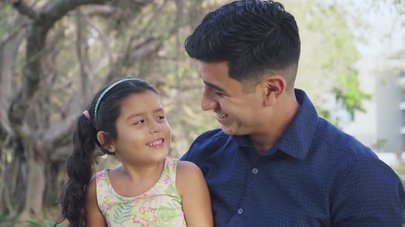 Dad and Daughter Smiling while Looking at Each Other