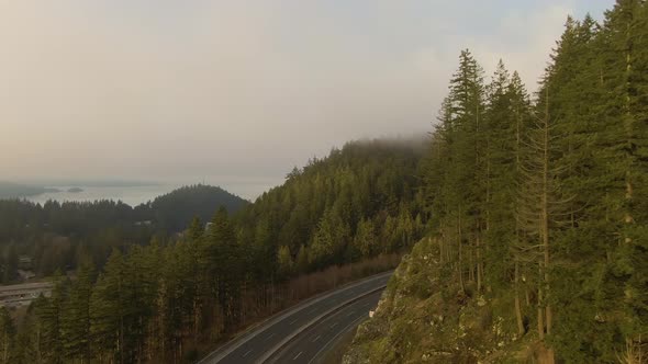 Aerial panoramic view of Sea to Sky Highway near Horseshoe Bay during a sunny winter evening before