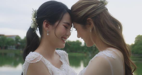Happy Asian Lesbian Married Couple Dancing In The Park.