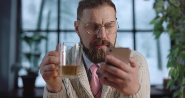 Man with Tea and Mobile at Home