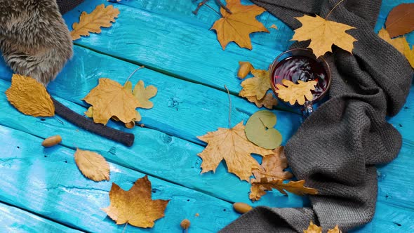 Yellow Foliage Falls On A Tea Table, Autumn Background With Tea And Leaves