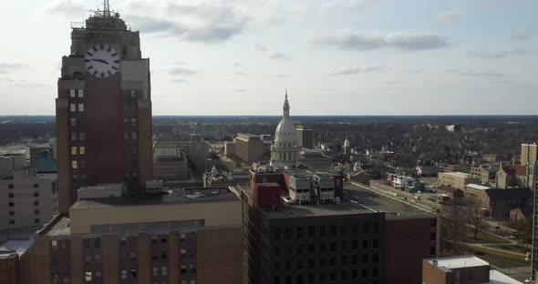 Michigan state capitol building with Boji Tower in Lansing, Michigan. Drone videoing up.