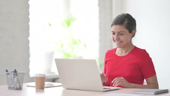 Indian Woman Talking on Video Call on Laptop in Office