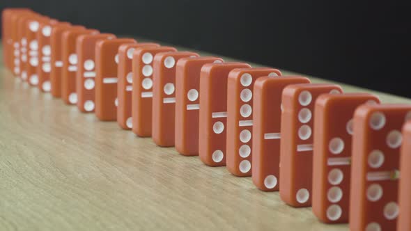 Domino Effect - Red Dominoes Falling Down the Chain