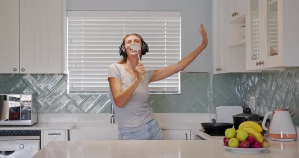 Portrait of Cheerful Woman Singing Song in Whisker on Dometic Kitchen in Slow Motion