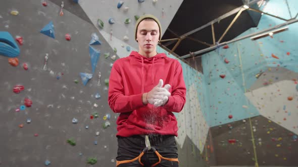 Young Caucasian Sportsman Applying Chalk on Hands