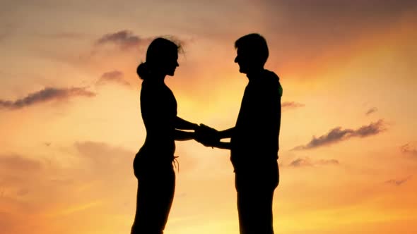 Silhouettes of Loving Man and Woman Kissing Tenderly at Sunset, Romantic Date