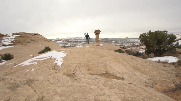 Walking towards man recording himself talking to camera