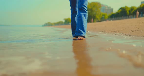 Bare Feet Walking Along the Seashore the Waves