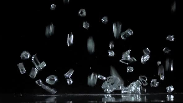 Crystals Fall on a Black Background. Slow Motion alt