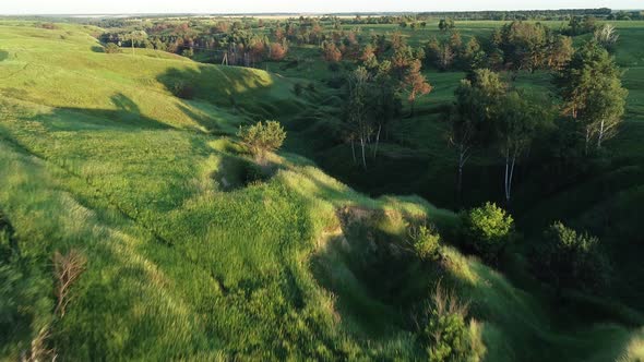 Aerial View of Beautiful Landscape with Hills and Green Field