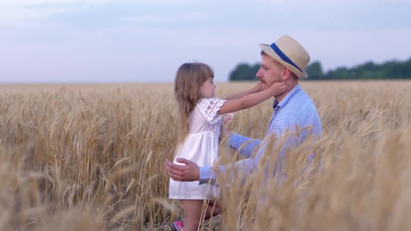 Funny Family Games, Man and a Girl Happy Family Playfully Play on the Field of Ripe Wheat Against