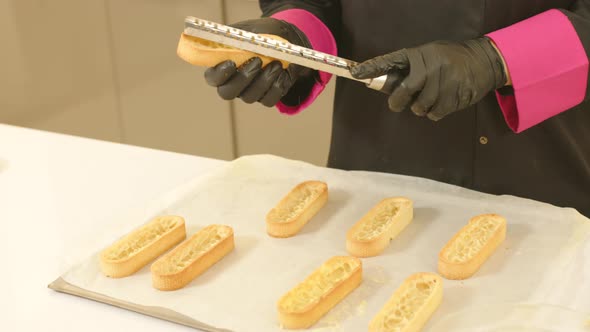 Close up gimbal shot of gloved hands mending ready made tartlet doughs