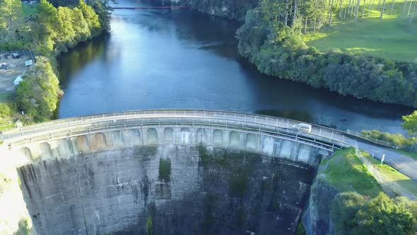 Aerial drone shot of Dam moving out to Bluewater, green trees and white birds flying by. New Zealand