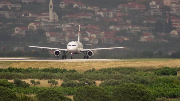 The Plane Goes on the Runway with a Background on the City