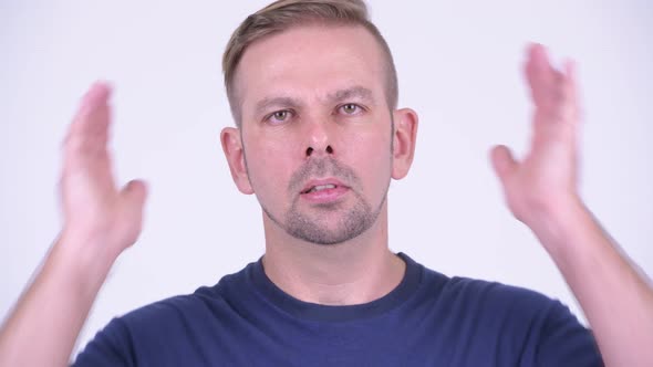 Portrait of Blonde Man Covering Ears As Three Wise Monkeys Concept