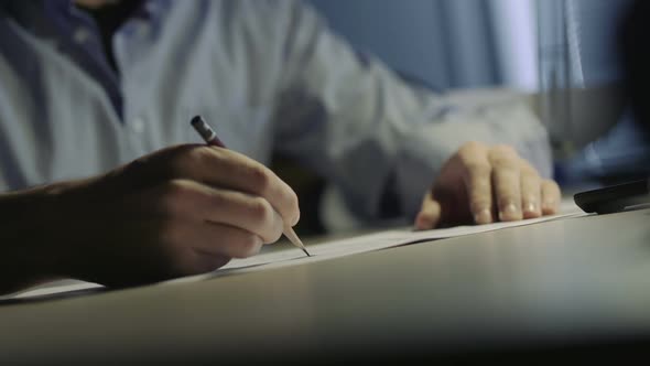 Young Man Artist Draws A Sketch In The Office at Night