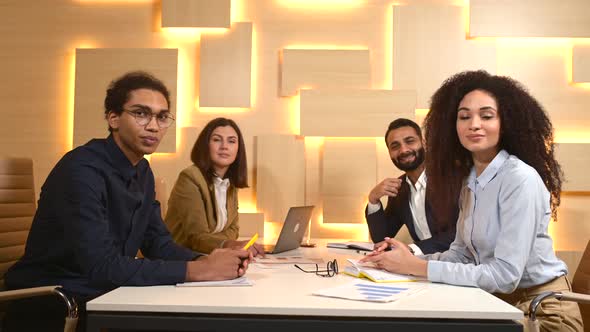 Young Workteam in Smart Casual Wear Waving to the Camera While Working in the Office