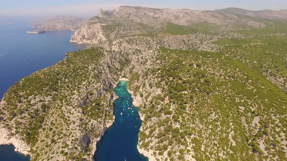 Aerial travel drone view of clear green water, cliffs of Cassis, Mediterranean Sea, Southern France.