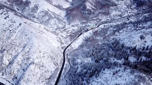 Snowy Mountains Winter Forest and Road with Cars