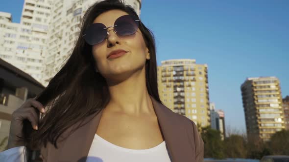 Beautiful Brunette Businesswoman In Business Clothes Walks In The City