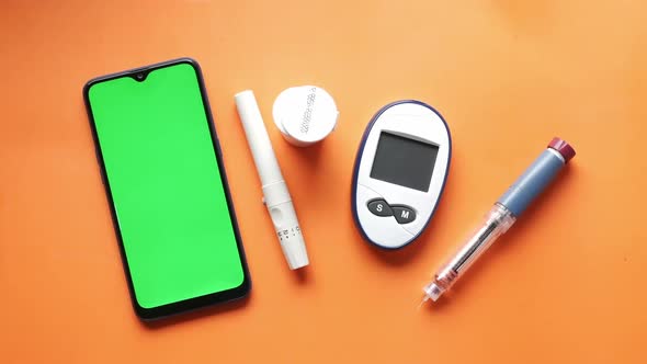 Smart Phone Insulin Diabetic Measurement Tools and Pills on Color Background