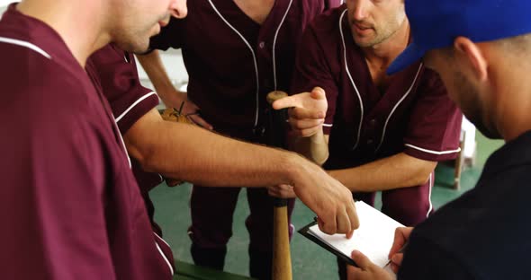 Coach discussing game plan with players