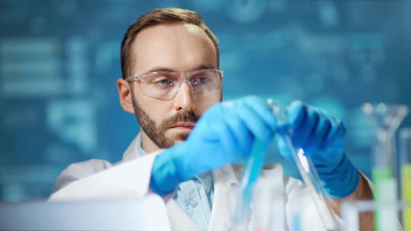 Medium Closeup Male Scientist Wearing Glasses and Gloves Working in Modern Laboratory