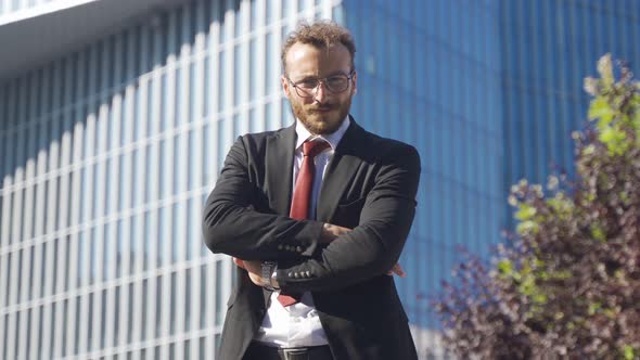 Business man looking at camera and smiling.