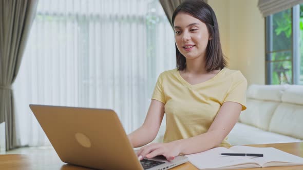 Distance learning of Caucasian Beautiful school girl study virtual online, watching video at home.