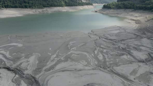 Aerial View Forwarding Shot Over the Receding Water Levels of Lake Ayous During Autumn Season with