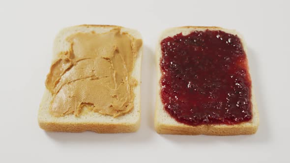 Close up view of peanut butter and jelly sandwich with copy space on white surface