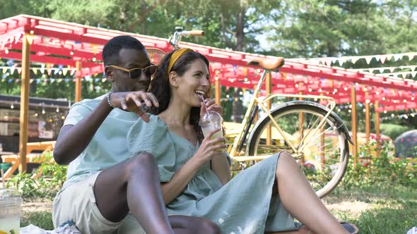 Black Man Sits in the Park with His Girlfriend and Tells Interesting Stories While Sitting on the