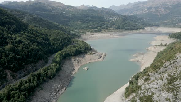 Aerial View Forwarding Shot Over the Receding Level Water of the Lake Ayous During Autumn Season