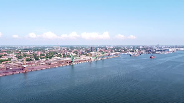 Klaipeda industrial harbor and city skyline in vibrant aerial drone view
