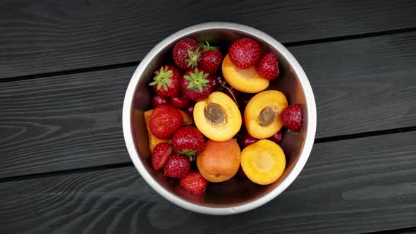 Apricot Strawberries Washed Bowls on Black Wooden Background