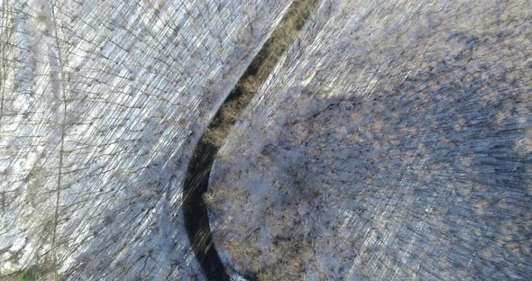 Awesome top down view of snowy forest. Road in mountains. Road with cars ,woods snowy forest