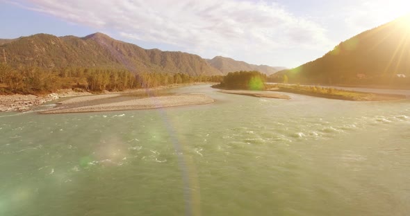 Low Altitude Flight Over Fresh Fast Mountain River with Rocks at Sunny Summer Morning.