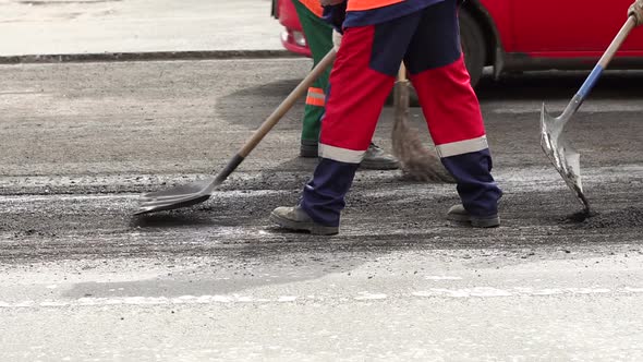 Workers Repair the Road in the City They Prepare the Old Asphalt for Cutting