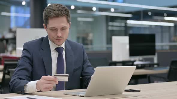 Businessman Making Successful Online Payment on Laptop