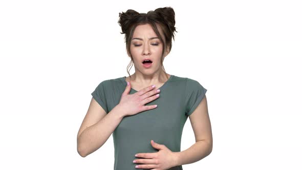Portrait of Young Woman Being Shocked and Scared Raising Hands to Mouth in Fear Isolated Over White