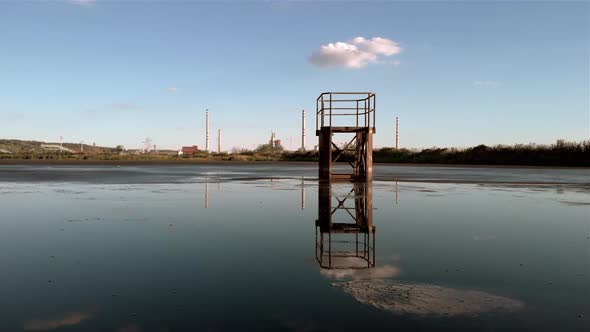 Lagoon sludge at the factory. Dolly camera movement. Wide shot.