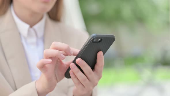 Close Up of Hands of Young Businesswoman Using Smartphone