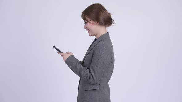 Profile View of Young Happy Asian Businesswoman with Phone Being Taken Away