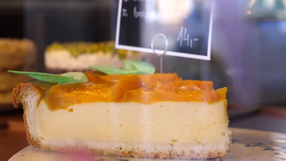 Peach Cheesecake On Display In Cafe