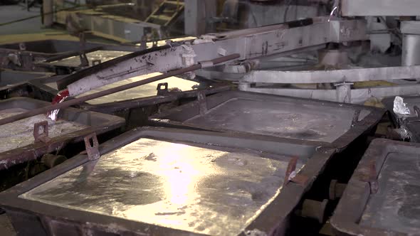 Close-up, the Hot Metal Is Poured From the Furnaces Special Baths. Aluminum, the Material That Is