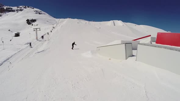 A young man snow boarding.