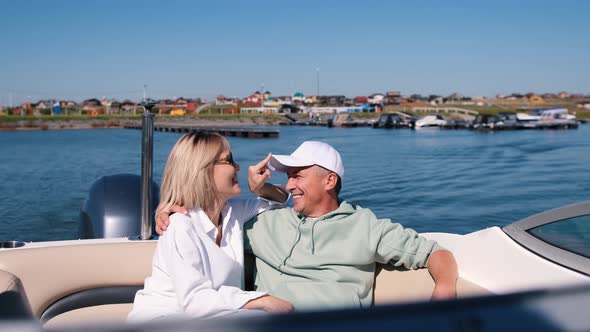 Young Woman and Man Ride a Speedboat