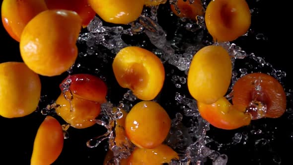 Apricots Flies To the Camera on a Black Background